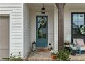 Close up of an inviting blue front door with wreath and brick pathway and an outdoor seating area at 228 Idylwilde Way, Canton, GA 30115