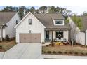 Beautifully designed cottage with a two-car garage, covered porch, and inviting curb appeal at 228 Idylwilde Way, Canton, GA 30115
