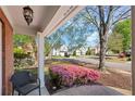 Inviting front porch with a view of a well-manicured lawn and a quiet, tree-lined street at 4070 Amber Leaf Dr, Roswell, GA 30076
