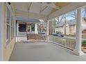 Inviting porch with a porch swing and white railings, offering a relaxing outdoor space at 873 Monroe Ne Cir, Atlanta, GA 30308