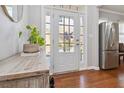 Bright foyer featuring a glass-paneled door, wood floors, and a stylish console table at 2319 White Alder Dr, Buford, GA 30519