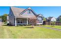 Well-maintained yard and covered porch enhancing the curb appeal of this beautiful home at 416 Blue Sky Cir, Acworth, GA 30102