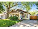 Charming bungalow featuring a well-manicured lawn, inviting front porch, and unique architectural details at 1450 Oglethorpe Sw Ave, Atlanta, GA 30310