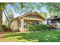 Charming bungalow featuring a well-manicured lawn, inviting front porch, and unique architectural details at 1450 Oglethorpe Sw Ave, Atlanta, GA 30310