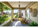 Inviting front porch with brick columns and relaxing seating area at 1450 Oglethorpe Sw Ave, Atlanta, GA 30310