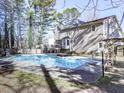 Spacious backyard featuring a refreshing in-ground pool and lush landscaping at 2311 October Nw Ct, Acworth, GA 30102