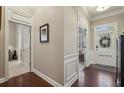Hallway featuring beautiful hardwood floors, white trim and access to other rooms at 5035 Castlegate Ct, Cumming, GA 30040