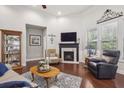 Bright living room with fireplace, hardwood floors, and plenty of natural light at 5035 Castlegate Ct, Cumming, GA 30040