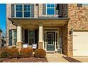 Charming front porch with seating, complemented by manicured landscaping and a welcoming entrance at 5390 Chestnut Dr, Cumming, GA 30040