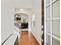 Inviting entryway with hardwood floors leads to a bright living space and staircase with modern white and wood finishes at 1519 Dolcetto Nw Trce # 1, Kennesaw, GA 30152