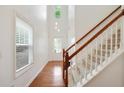 Bright entryway featuring hardwood floors, stairs, a window, and a clear view of the front door and high ceilings at 1519 Dolcetto Nw Trce # 1, Kennesaw, GA 30152