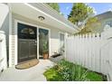 Inviting front entry with a black door, well-manicured garden, and classic white fence at 2693 Greentree Se Dr, Marietta, GA 30067
