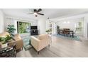 Bright living room featuring neutral furniture, ceiling fan and large windows at 2693 Greentree Se Dr, Marietta, GA 30067