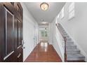 Inviting foyer with hardwood floors, staircase, and plenty of natural light at 2732 Pierce Brennen Ct, Lawrenceville, GA 30043
