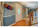 Inviting foyer featuring a decorative front door, wood floors, and staircase at 293 Country Lake Dr, Mcdonough, GA 30252