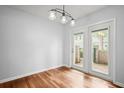 Bright dining room featuring beautiful hardwood floors and a stylish light fixture at 6940 Roswell Rd # 24E, Sandy Springs, GA 30328