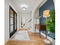 Bright foyer featuring hardwood floors, stylish lighting, and a unique architectural archway at 2433 Helmsdale Ne Dr, Atlanta, GA 30345