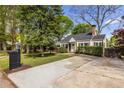 Picturesque home with a long driveway and a vibrant green lawn, surrounded by mature trees and bushes at 1010 Eden Se Ave, Atlanta, GA 30316