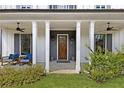 Inviting front porch with comfortable seating and stylish accents, perfect for relaxation and entertaining at 1911 Commons Cir, Brookhaven, GA 30341