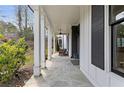 Relaxing covered porch, showcasing a charming outdoor space with stone flooring and seating at 1911 Commons Cir, Brookhaven, GA 30341
