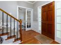 Welcoming foyer with hardwood floors, staircase, and view into another room at 4270 Parnell Rd, Marietta, GA 30062