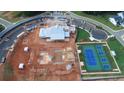Overhead view showcasing home construction, tennis courts, and community development at 559 Southland Cir, Canton, GA 30115