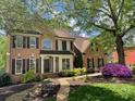 Classic brick home with professionally landscaped yard and covered entrance at 131 Helmswood Sw Cir, Marietta, GA 30064