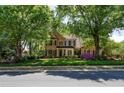 Inviting brick home featuring dark shutters, blooming azaleas, and a neatly landscaped front yard at 131 Helmswood Sw Cir, Marietta, GA 30064