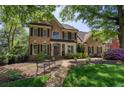 Charming brick home with manicured landscaping, a welcoming front porch and a bench at 131 Helmswood Sw Cir, Marietta, GA 30064