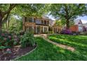 Beautiful brick home with a lush, green lawn and colorful flowerbeds enhancing its curb appeal at 131 Helmswood Sw Cir, Marietta, GA 30064