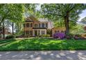 Traditional brick residence with a well-maintained lawn and mature trees creating a serene setting at 131 Helmswood Sw Cir, Marietta, GA 30064