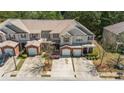 An elevated view of the lovely townhome, with brick accents and attached garages in a serene setting at 168 Ellis Dr, Conyers, GA 30012