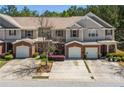 Beautiful townhome featuring brick facade, attached garage, and landscaped front yard under a bright sky at 168 Ellis Dr, Conyers, GA 30012