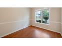 Comfortable living room showcasing a bright window view and beautiful hardwood floors, creating a cozy ambiance at 272 Ascott Ln, Woodstock, GA 30189