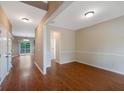 Bright open-concept living area with hardwood floors and natural light, seamlessly connecting to other spaces at 272 Ascott Ln, Woodstock, GA 30189