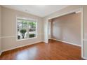 Inviting living room featuring a large window that fills the room with light and showcases the hardwood floors at 272 Ascott Ln, Woodstock, GA 30189