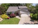 Aerial view of a charming home featuring a well-manicured lawn, complemented by vibrant flowers and a double-door entryway at 890 Muirfield Rdg, Marietta, GA 30068