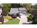 Charming home featuring a well-manicured lawn, complemented by vibrant flowers and a double-door entryway at 890 Muirfield Rdg, Marietta, GA 30068
