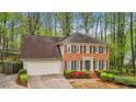 Charming brick home with manicured landscaping, two-car garage, and a welcoming front entrance at 989 Vendue Dr, Lawrenceville, GA 30044