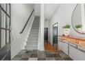 Welcoming entryway with slate floors, carpeted stairs, and stylish console table with mirror at 2430 Dresden Parc Cir, Atlanta, GA 30345