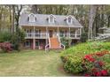 Classic two-story home with a spacious front porch perfect for relaxing at 2962 Moorings Pkwy, Snellville, GA 30039