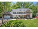 Beautiful two-story home with stone accents, a manicured lawn, and an attached two-car garage at 4152 Club Ne Dr, Atlanta, GA 30319
