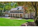 Charming two-story home with a manicured lawn, stone accents, and an attached two-car garage at 4152 Club Ne Dr, Atlanta, GA 30319