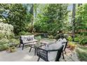 Outdoor patio with comfortable seating, manicured landscaping, and a peaceful ambiance at 5515 Cross Gate Ct, Sandy Springs, GA 30327