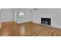 Bright living room with modern fireplace, light colored walls, and laminate wood floor at 907 Country Park Se Dr, Smyrna, GA 30080