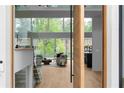 Bright, open-concept living room with floor-to-ceiling windows and modern finishes, offers natural light and stunning views at 2650 Fairoaks Rd, Decatur, GA 30033