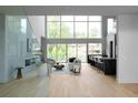 Light-filled living room boasts floor-to-ceiling windows, fireplace and modern kitchen with breakfast bar offers seamless indoor-outdoor living at 2650 Fairoaks Rd, Decatur, GA 30033