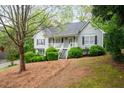 Well-kept home with lush landscaping, a sloped lawn, and inviting porch at 350 Spring View Ct, Dallas, GA 30157