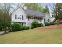 Charming gray home with white trim, black shutters, landscaped front yard, and inviting front porch at 350 Spring View Ct, Dallas, GA 30157