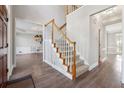 Inviting foyer with hardwood flooring, staircase with wooden banister, and views into adjacent rooms at 760 Woodrow Dr, Lawrenceville, GA 30043